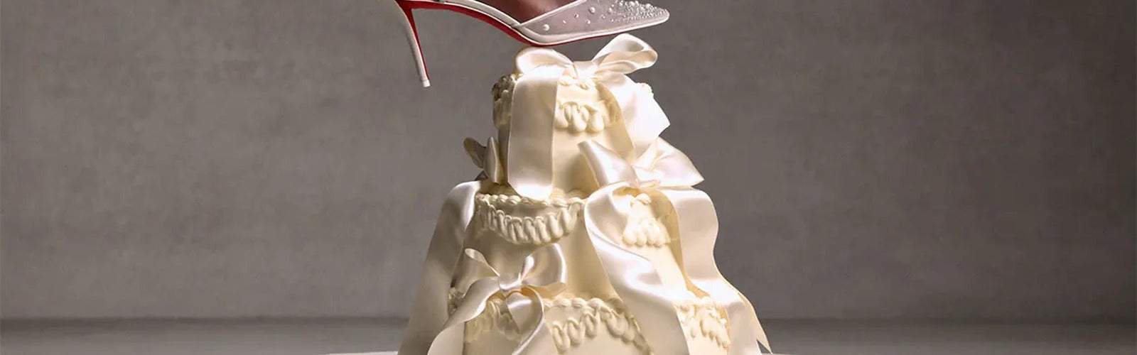 Christian Louboutin Bridal 2026 wedding shoes with red sole on wedding cake - Avantelle