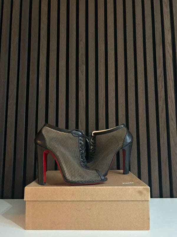 Christian Louboutin Nikita 100mm heel Black Leather, pre-owned authenticated UK, close-up detail Christian Louboutin Nikita Fishnet Ankle Boots Black (EU 40 / UK 7) - heel and construction