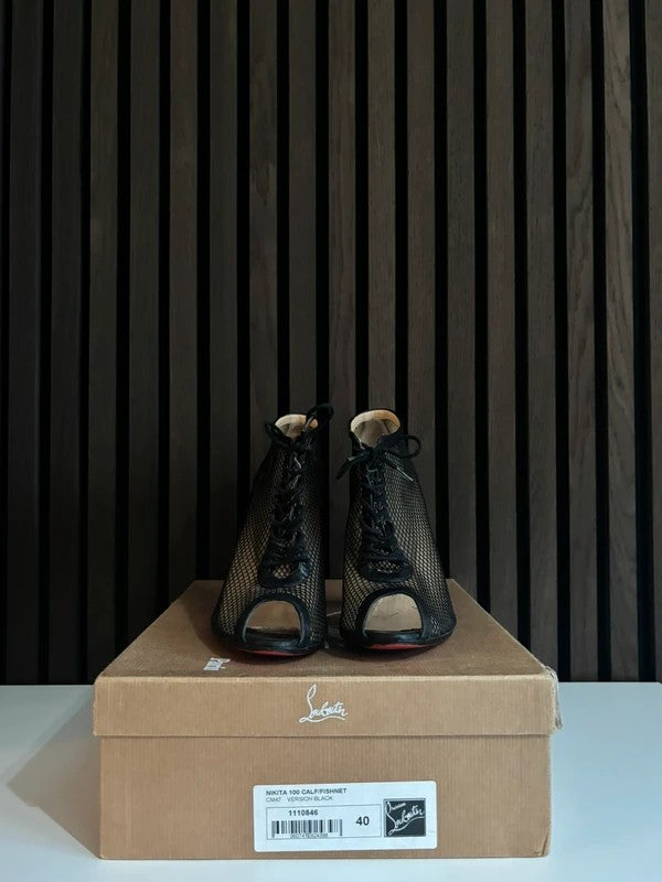 Christian Louboutin Nikita 100mm heel Black Leather, pre-owned authenticated UK, side view Christian Louboutin Nikita Fishnet Ankle Boots Black (EU 40 / UK 7) - alternate angle